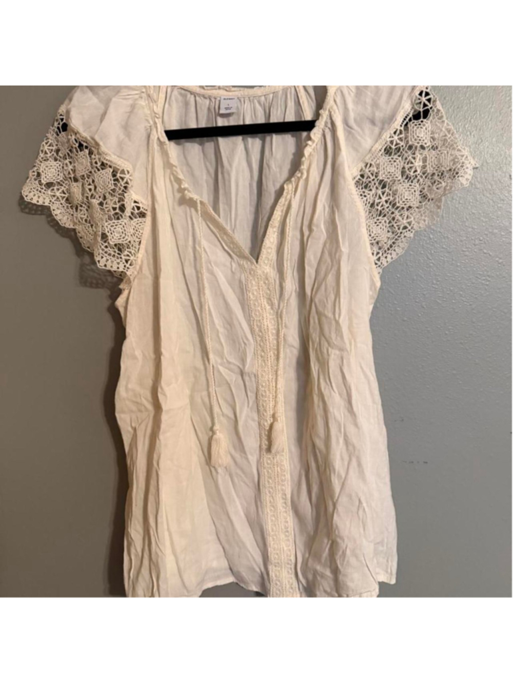 Ivory boho crochet lace blouse with statement flutter sleeves, tassel tie neckli